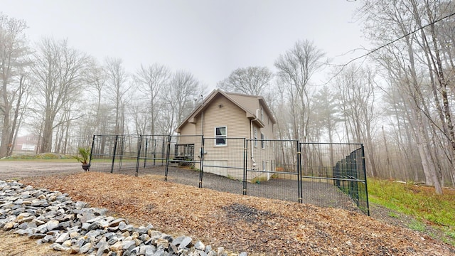 view of side of home with a gate and fence