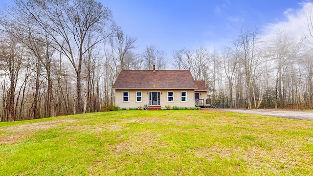 view of front facade featuring a front lawn and a chimney