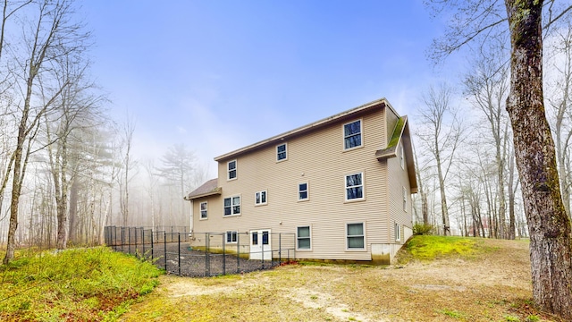 rear view of property with fence
