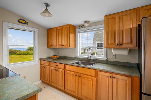 20 Long Point Is, Harpswell, ME 04079 - kitchen with a sink, freestanding refrigerator, dark countertops, brown cabinetry, and vaulted ceiling