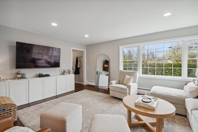 living area featuring a baseboard radiator, a baseboard heating unit, recessed lighting, dark wood-type flooring, and baseboards