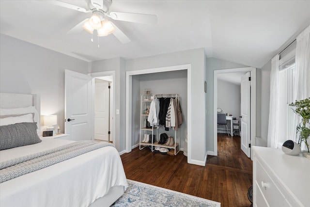 bedroom featuring dark wood finished floors, a closet, vaulted ceiling, ceiling fan, and baseboards