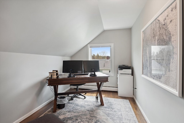office area featuring wood finished floors, vaulted ceiling, a baseboard heating unit, and baseboards