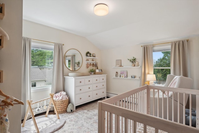 bedroom with multiple windows, vaulted ceiling, a nursery area, and a baseboard heating unit