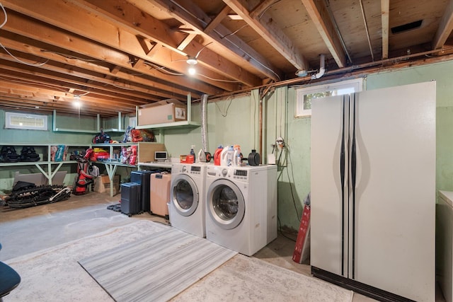 clothes washing area with separate washer and dryer