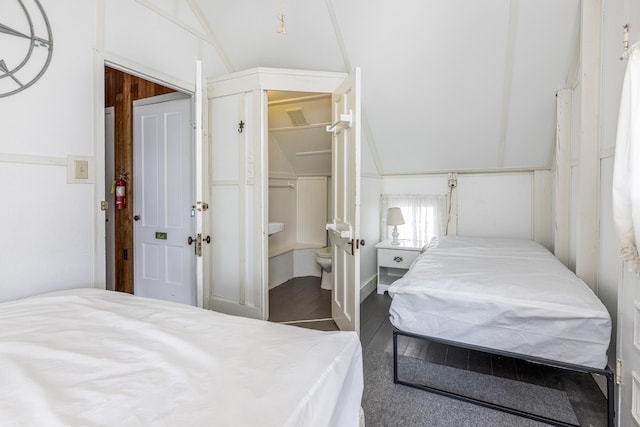 bedroom featuring lofted ceiling and a closet