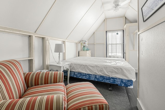 bedroom featuring vaulted ceiling, carpet flooring, and a textured wall