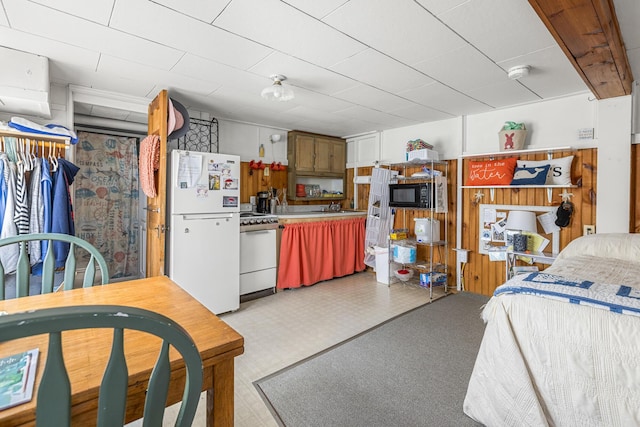 kitchen featuring white appliances, light floors, light countertops, and a sink