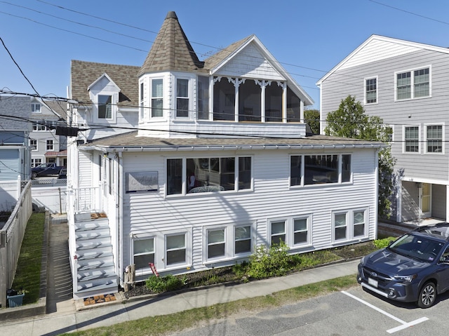 view of front of property with roof with shingles and uncovered parking