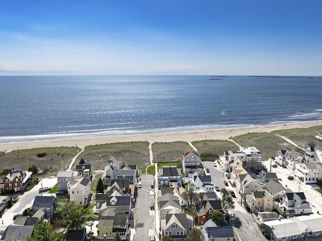 view of property location with expansive beach and nearby suburban area
