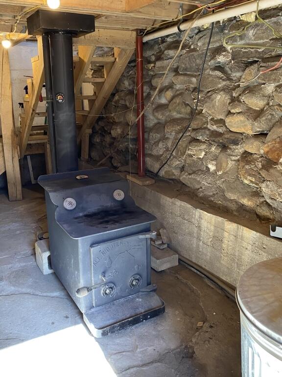 detailed view of a wood stove and unfinished concrete flooring
