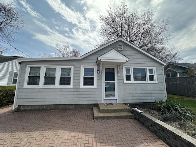 view of front of house featuring fence and a patio area