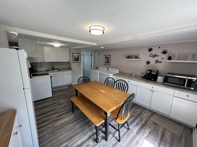 dining area featuring washer and dryer and dark wood-type flooring