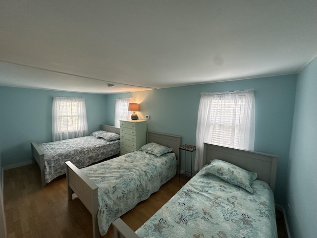bedroom featuring dark wood-type flooring and baseboards