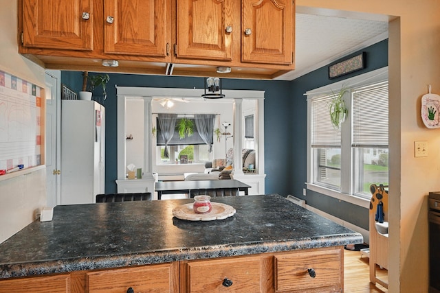 kitchen with brown cabinets and dark stone counters