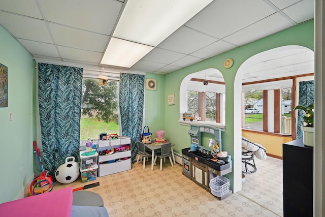 playroom with a paneled ceiling