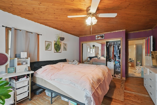 bedroom with wood ceiling, a closet, wood finished floors, and a ceiling fan