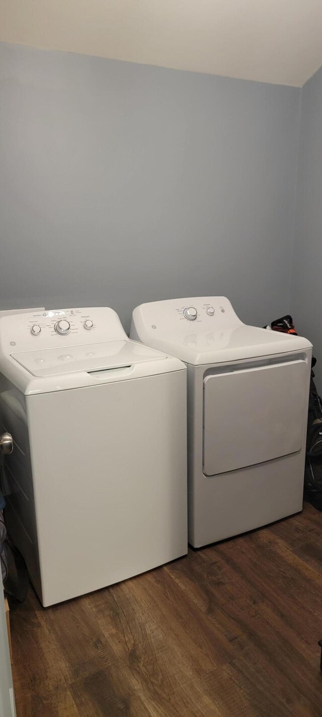 laundry area with independent washer and dryer and dark wood finished floors