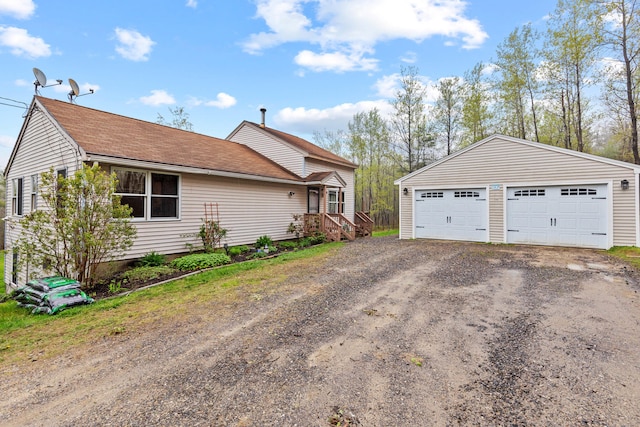 150 Holmes Rd, Scarborough, ME 04074 - view of property exterior featuring a garage, an outbuilding, and roof with shingles