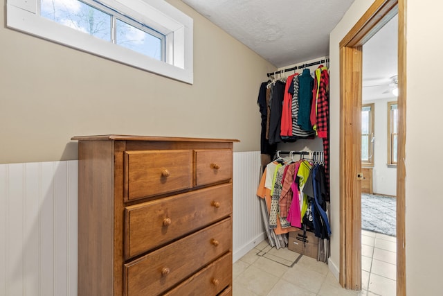 150 Holmes Rd, Scarborough, ME 04074 - spacious closet featuring light tile patterned floors and ceiling fan