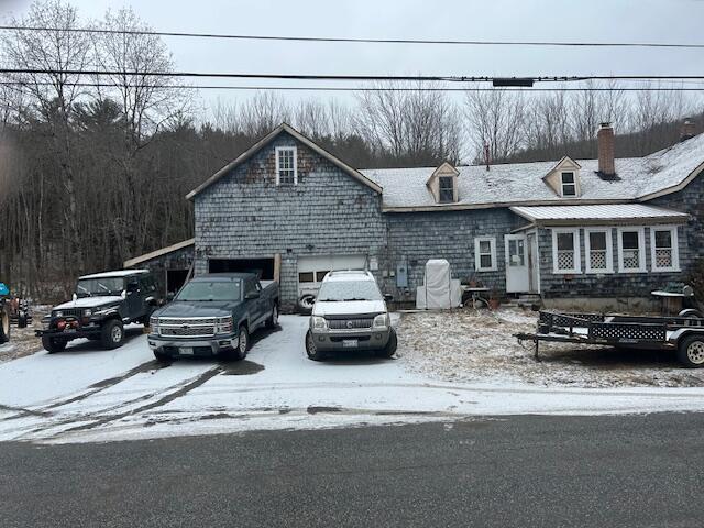 217 Dickvale Rd, Peru, ME 04290 - view of front facade with a garage, a chimney, and concrete driveway
