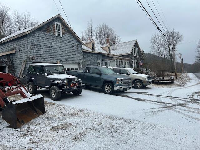 217 Dickvale Rd, Peru, ME 04290 - snow covered parking area featuring a garage