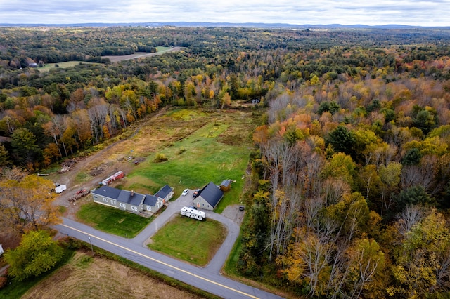 view of property location featuring a forest