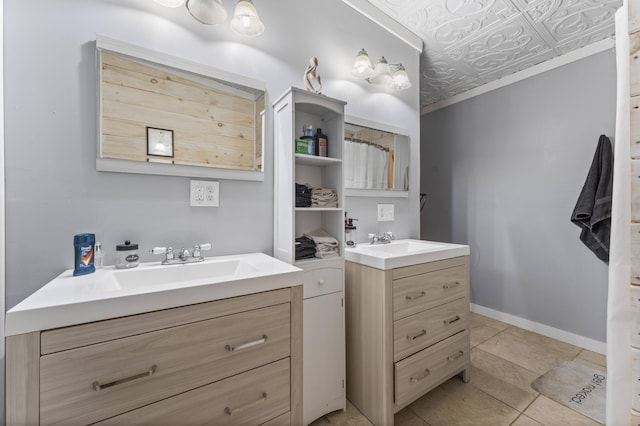 full bathroom with two vanities, an ornate ceiling, baseboards, and tile patterned flooring