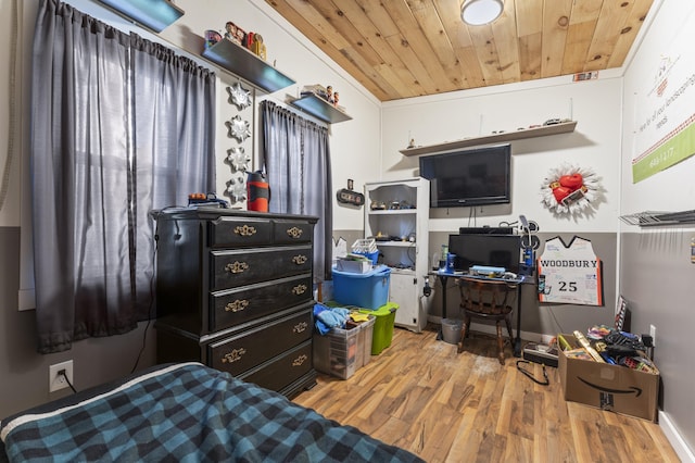 bedroom with wood ceiling and wood finished floors