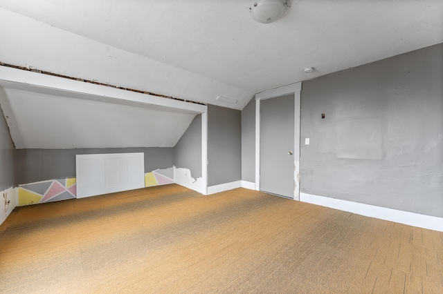 bonus room with vaulted ceiling, carpet, and baseboards