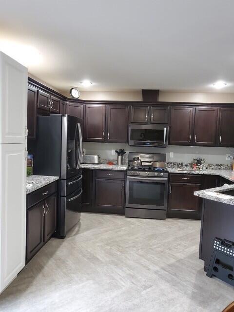 4 Maggie Way, Ellsworth, ME 04605 - kitchen featuring stainless steel appliances, dark brown cabinets, and light stone counters
