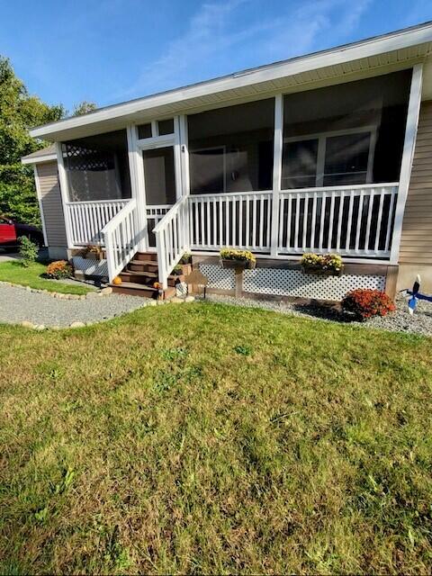 4 Maggie Way, Ellsworth, ME 04605 - rear view of house with a sunroom and a lawn