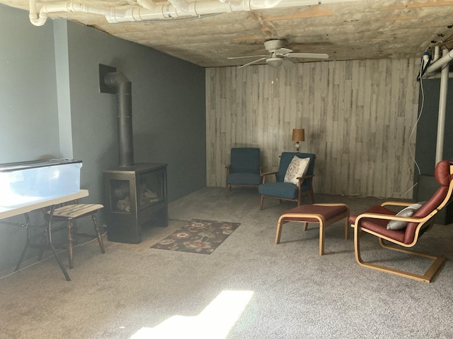 4 Maggie Way, Ellsworth, ME 04605 - sitting room with a wood stove, wooden walls, ceiling fan, and carpet