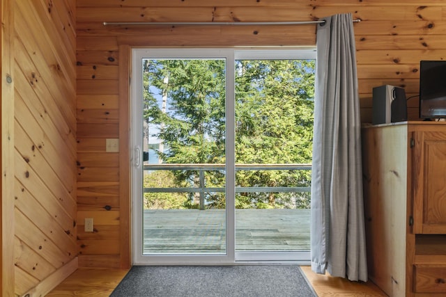 entryway with wood walls