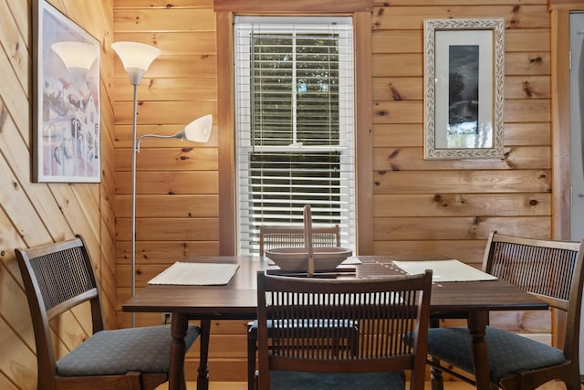 dining room featuring wooden walls