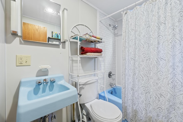 full bathroom featuring toilet, a sink, and shower / tub combo with curtain
