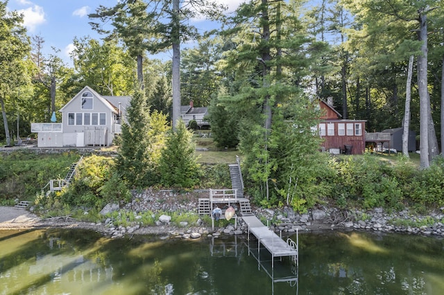 dock area featuring view of scattered trees and stairs