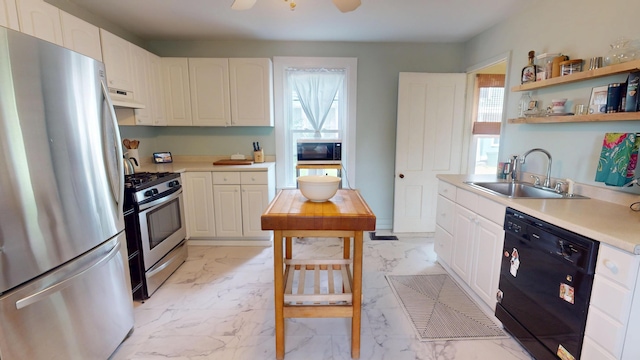 21 Fern St, Bangor, ME 04401 - kitchen with appliances with stainless steel finishes, a sink, under cabinet range hood, light marble finish flooring, and light countertops