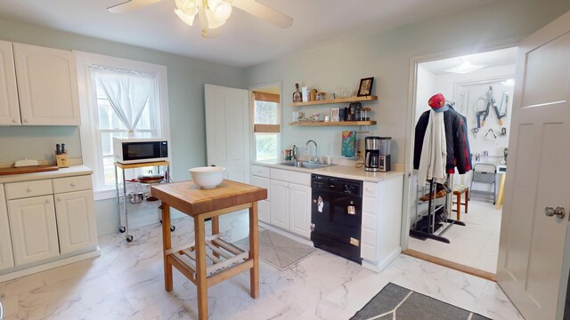 21 Fern St, Bangor, ME 04401 - kitchen with black appliances, a sink, ceiling fan, light countertops, and light marble finish floors