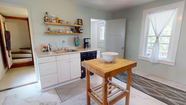 21 Fern St, Bangor, ME 04401 - kitchen with a sink, dishwasher, light marble finish flooring, and white cabinets