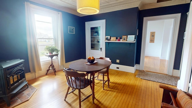 21 Fern St, Bangor, ME 04401 - dining room with a wood stove, hardwood / wood-style flooring, and plenty of natural light