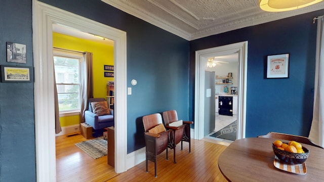 21 Fern St, Bangor, ME 04401 - hall with hardwood / wood-style flooring, baseboards, ornamental molding, and an ornate ceiling