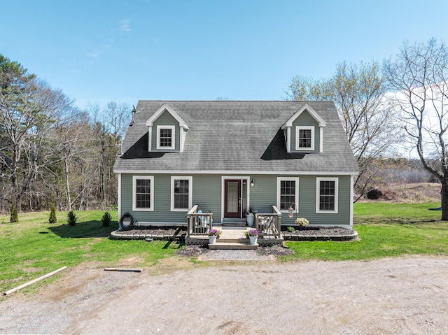 cape cod home with a front yard