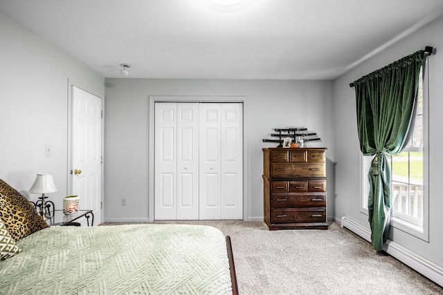 carpeted bedroom featuring a closet and baseboards