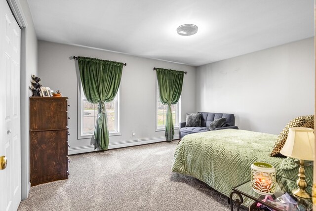 carpeted bedroom featuring baseboard heating and baseboards