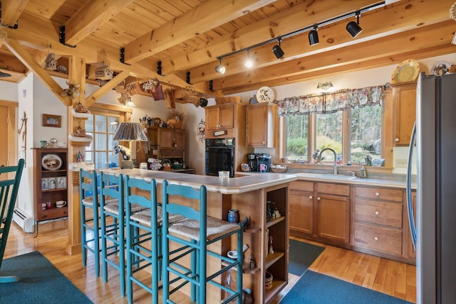 237 River Rd, Avon, ME 04966 - kitchen featuring freestanding refrigerator, oven, a sink, wood ceiling, and light wood finished floors