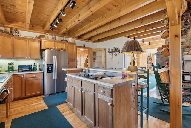 237 River Rd, Avon, ME 04966 - kitchen featuring stainless steel fridge with ice dispenser, rail lighting, black electric stovetop, a kitchen island, and wood ceiling