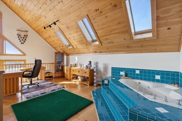 237 River Rd, Avon, ME 04966 - bathroom featuring a skylight, vaulted ceiling, wood ceiling, hardwood / wood-style floors, and a garden tub