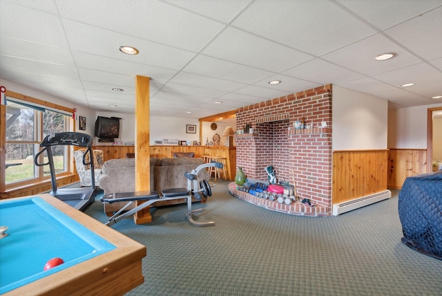 237 River Rd, Avon, ME 04966 - rec room featuring wooden walls, a baseboard heating unit, wainscoting, carpet, and a drop ceiling
