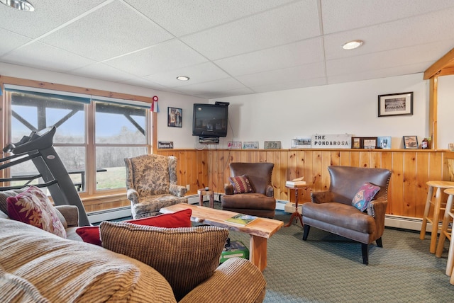237 River Rd, Avon, ME 04966 - carpeted living room featuring a wainscoted wall, a paneled ceiling, a baseboard heating unit, and wood walls